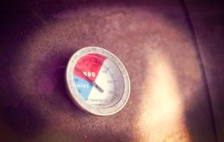 The temperature gauge on the smoker